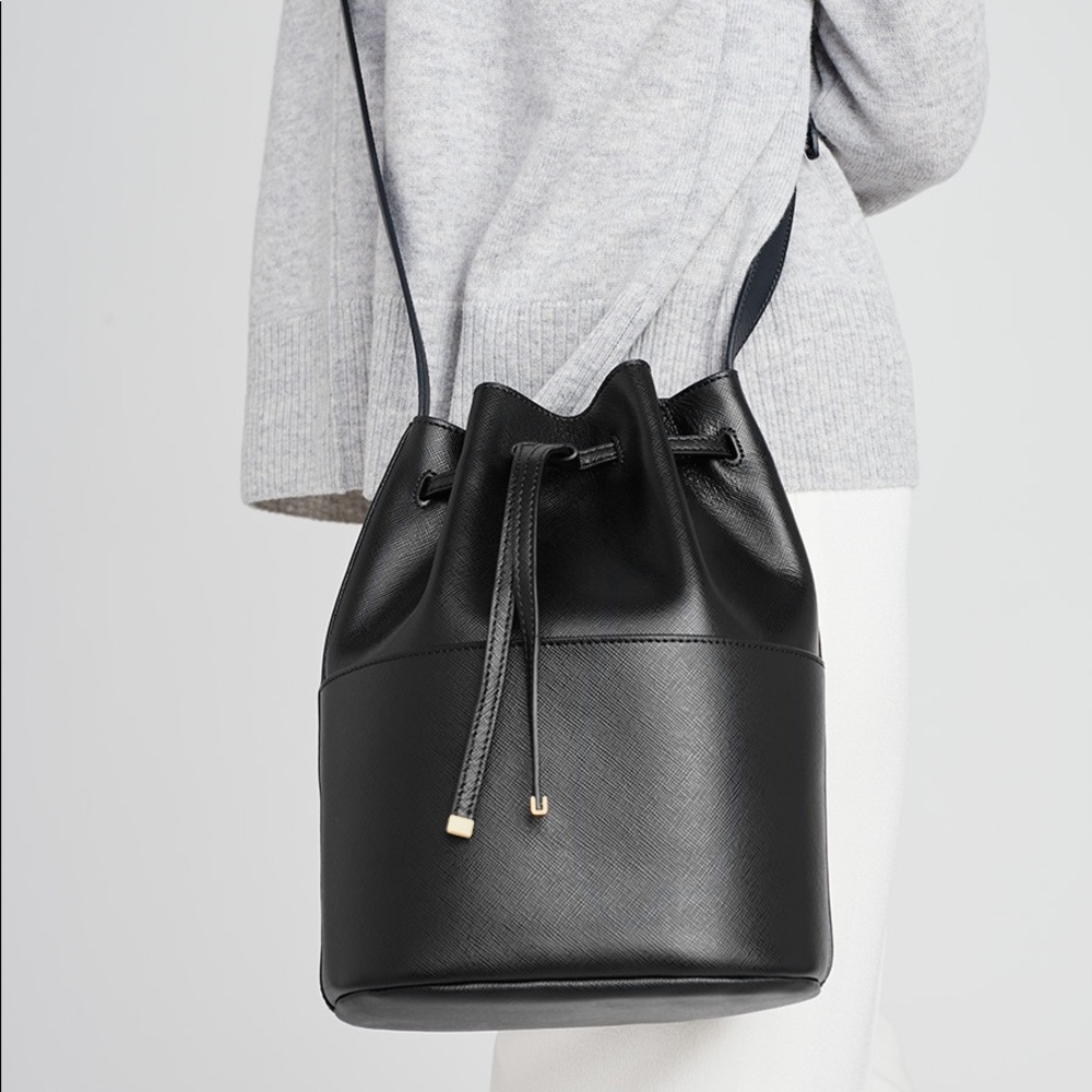Cuyana Mini Bucket Crossbody Bag in black saffiano leather and gold hardware
